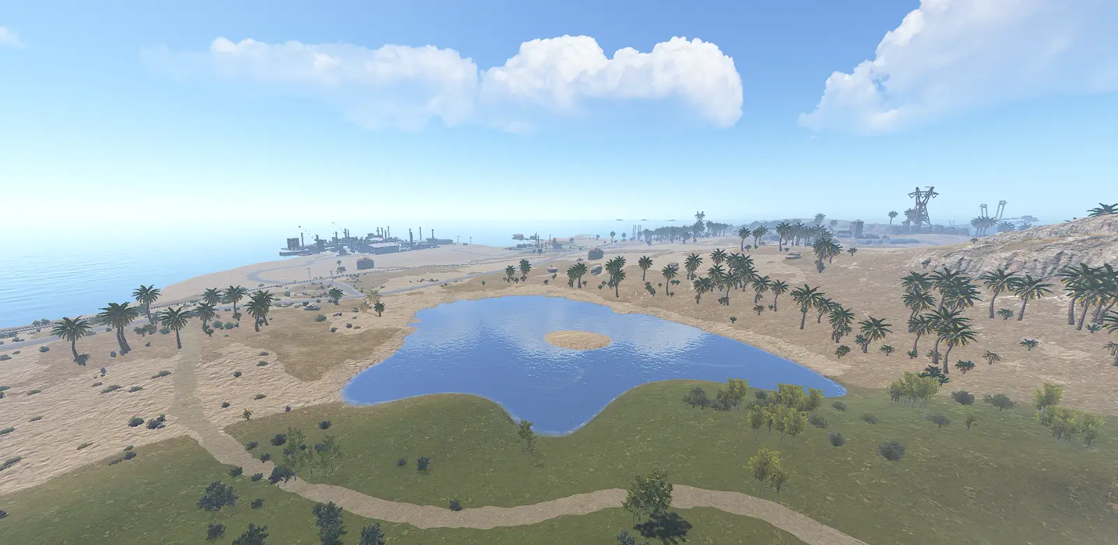 A lake surrounded by palm trees and sand dunes, with industrial monuments on the coast